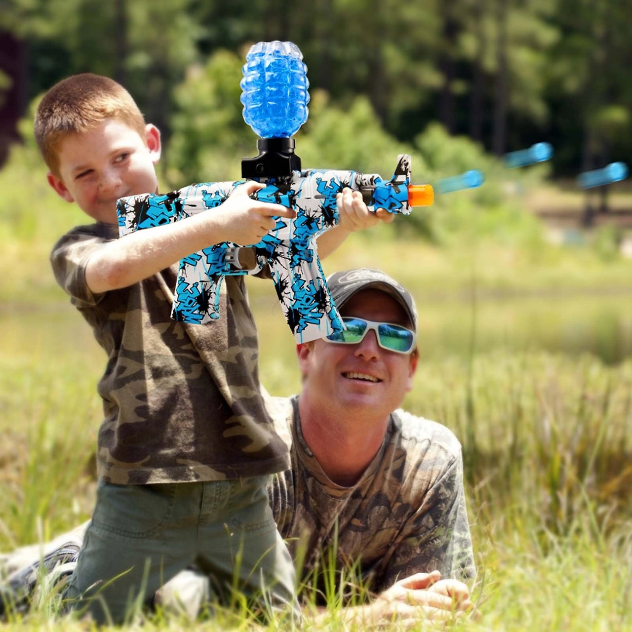 Children and adults are holding blue water guns and shooting gel blast bullets.