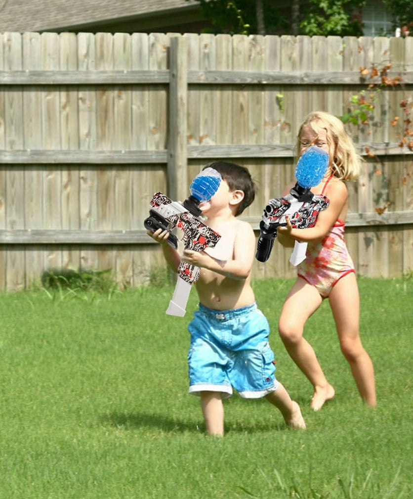 Two children playing with water guns in a backyard
