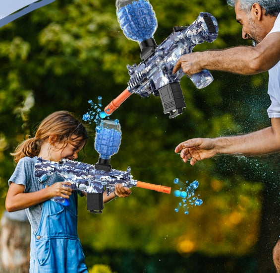 Father and child having a water fight outdoors with eco-friendly gel blaster bullets